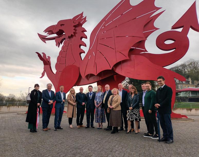 The Lord Mayor of London stands with members of the Western Gateway partnership in front of the University of South Wales' welsh dragon statue